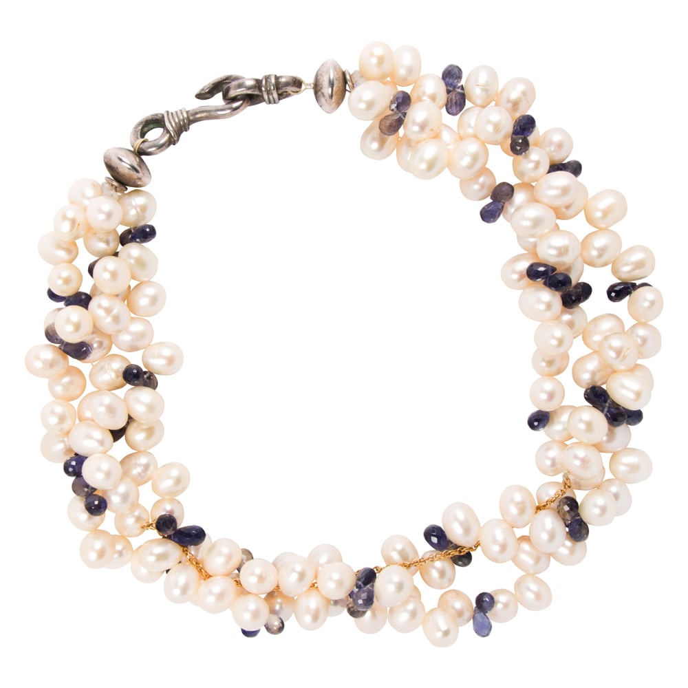 A retailed by Gump's cultured pearl, iolite, and silver necklace: A retailed by Gump's cultured pearl, iolite, and silver necklace Designed as a triple strand of baroque cultured pearls, interspersed by clusters of two briolette-cut iolites; length: 17 1/2 in;