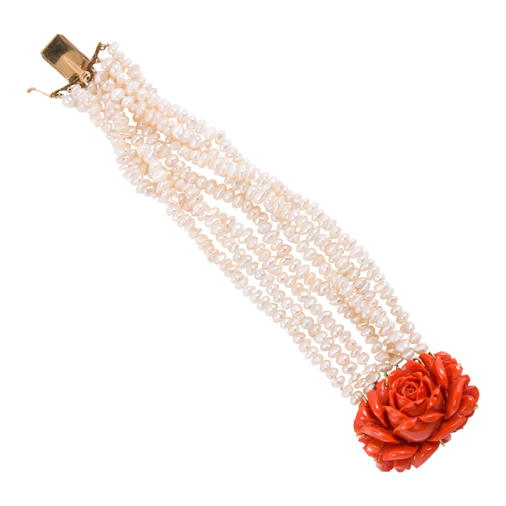 A coral, cultured pearl, and 14k gold bracelet: A coral, cultured pearl, and 14k gold bracelet Designed as a strand of seven baroque cultured pearls, on clasp set with a floriform coral carving measuring 1 1/2 x 1 in; length: 6 in; 49.00 grams