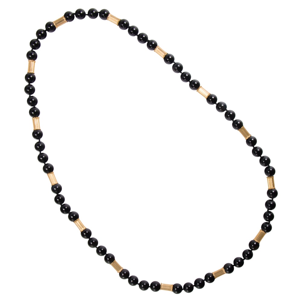 An onyx and 14k gold necklace: An onyx and 14k gold necklace Featuring round-shaped onyx beads measuring 10.00 mm, interspersed by tube-shaped 14k gold spaces measuring approximately 11.77 x 6.13 mm; length: 30 in; 81.05 grams