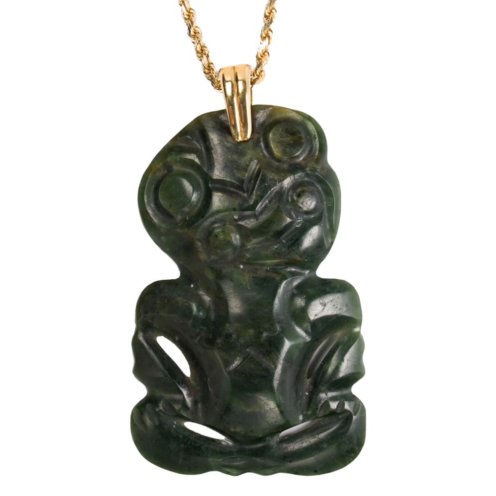 A large Hei Tiki jade and 14k gold pendant necklace: A large Hei Tiki jade and 14k gold pendant necklace Featuring a Maori-style carved seated figure, on modified twisted rope chain; pendant length: 4 3/4 in; chain length: 22 in; 122.80 grams