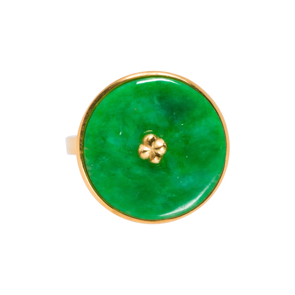 A jade and 14k gold ring: A jade and 14k gold ring Centering a jade bi disc measuring 15.55 mm across; size 7; 4.10 grams