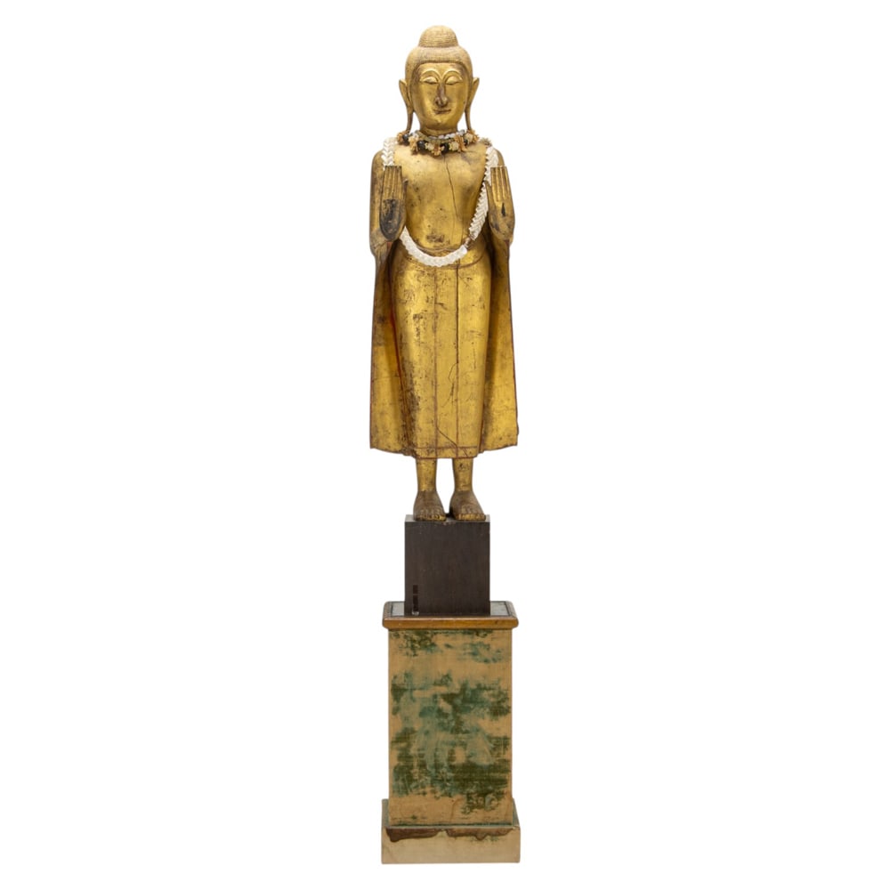 A large Burmese gilt wood figure of Buddha: A large Burmese gilt wood figure of Buddha. Mandalay style with pedestal, late 19th/early 20th century, 81"h x 14"w x 13.5"d (on pedestal): 57"h x 8.5"sq (statue)
