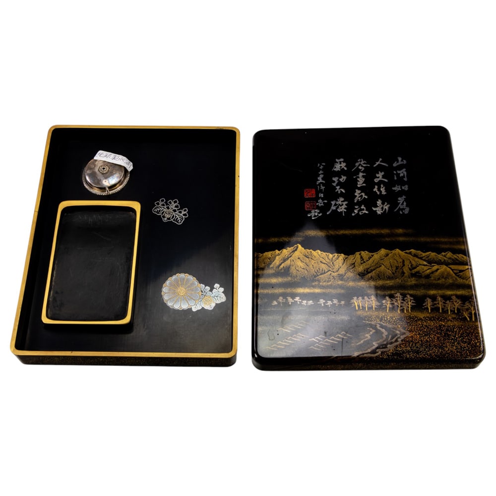 A Japanese lacquer suzuribako (writing box): A Japanese lacquer suzuribako (writing box). Featuring landscape and inscription, with wooden storage box, Meiji period, 1.5"h x 7.25"w x 9.25"d.