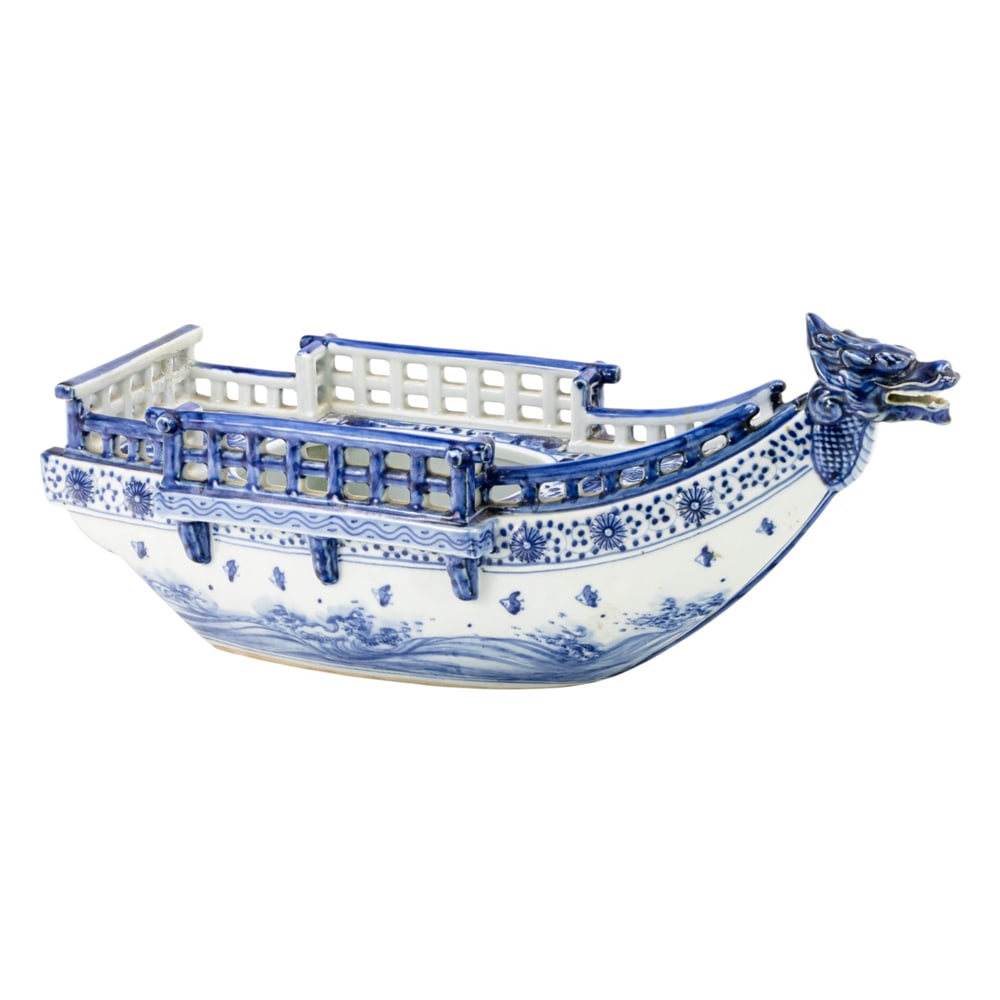 A Japanese Hirado blue and white 'dragon' boat: A Japanese Hirado blue and white 'dragon' boat. Decorated with floral sprays, wave borders, and phoenix motif, early 20th century, 16.5" across.