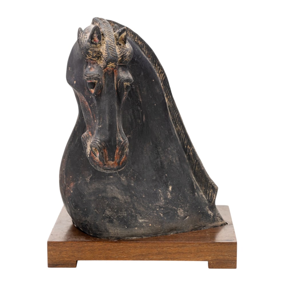 A Chinese black pottery horse head: A Chinese black pottery horse head. Han dynasty, 13.25" high excluding stand.