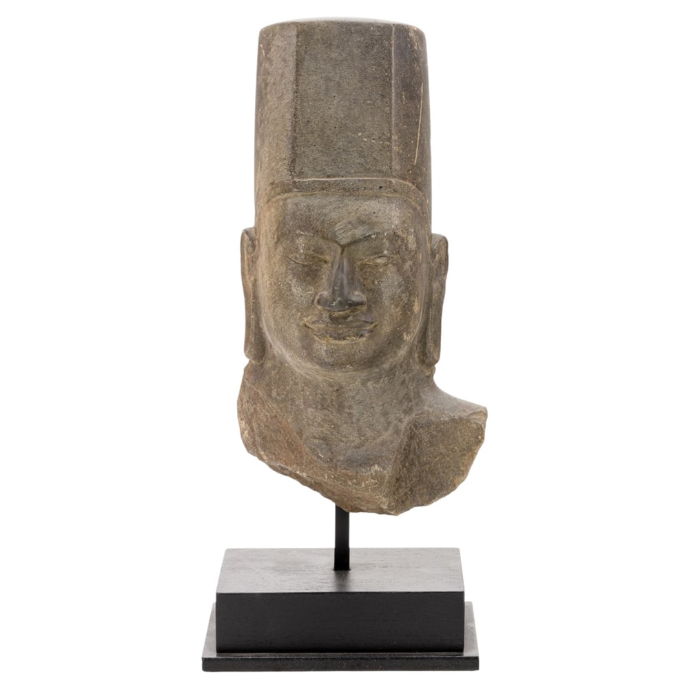 A Pre-Angkor head: A Pre-Angkor head. Possibly 7th to 8th century, 12.5" high excluding stand. Provenance: 1994 purchased at Sculpture Gallery, Hong kong.