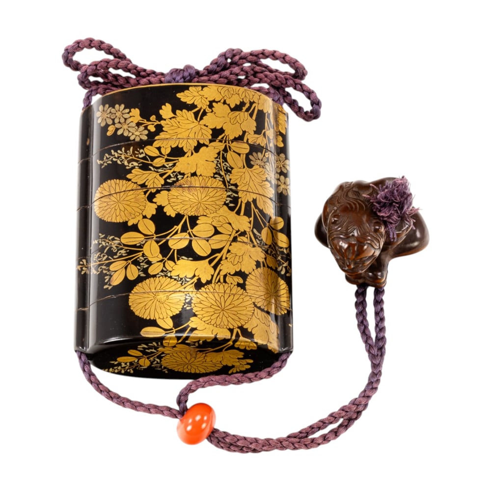 A Japanese lacquer four-case inro by Shunsho: A Japanese lacquer four-case inro by Shunsho. Decorated in gold maki-e with blossoming chrysanthemum, fitted with a red lacquer ojime and boxwood netsuke of demon, signed Shunsho on the base, 3.25"