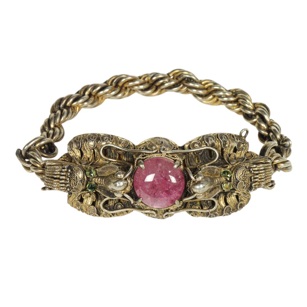 A Chinese gilt silver filigree and pink tourmaline 'dragon' bracelet: A Chinese gilt silver filigree and pink tourmaline 'dragon' bracelet. Republic period, 2.25" wide, 45.5 grams total weight.