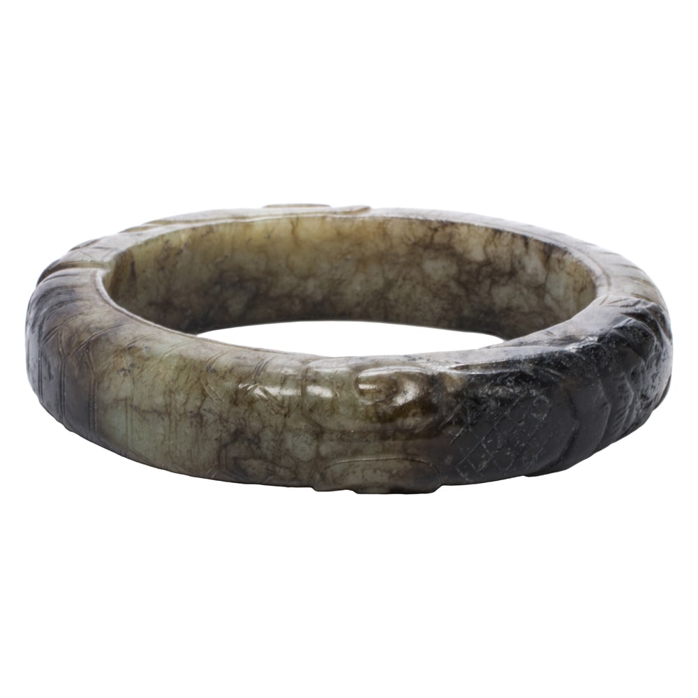 A Chinese mottled jade bangle bracelet: A Chinese mottled jade bangle bracelet. 2.625" across.