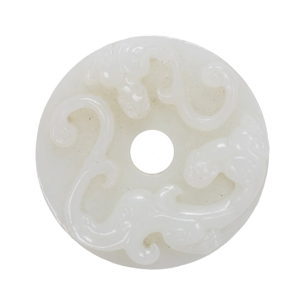 A Chinese white jade bi disc: A Chinese white jade bi disc. Featuring chilong figure, 2.125" across.