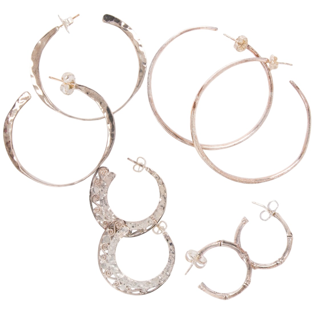 Four pairs of silver hoops: Four pairs of silver hoops The hoops of varying styles; gross weight: 38.15 grams