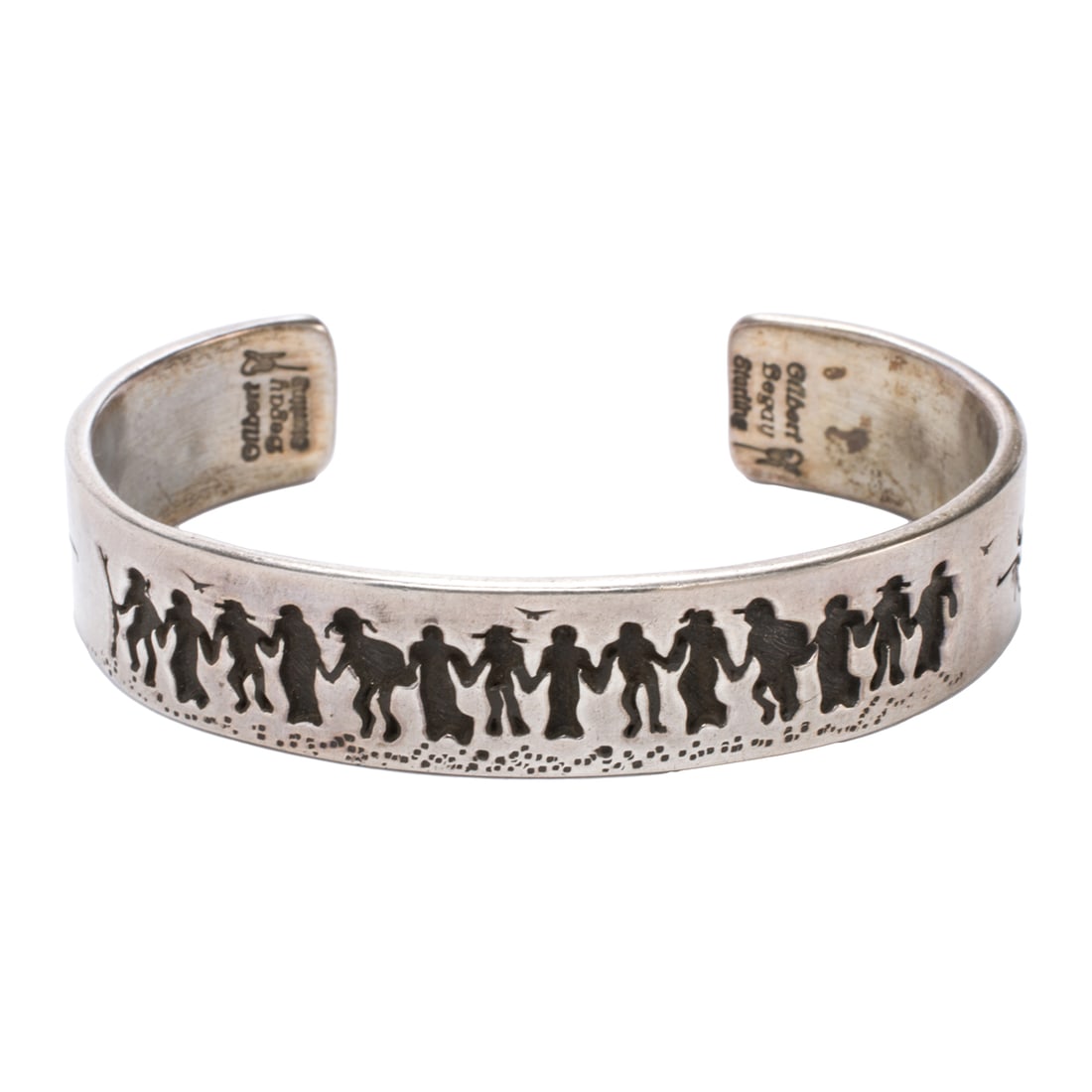 A Gilbert Begay sterling silver cuff: A Gilbert Begay sterling silver cuff Featuring dancing figures; length: 5 3/4 in; 32.30 grams