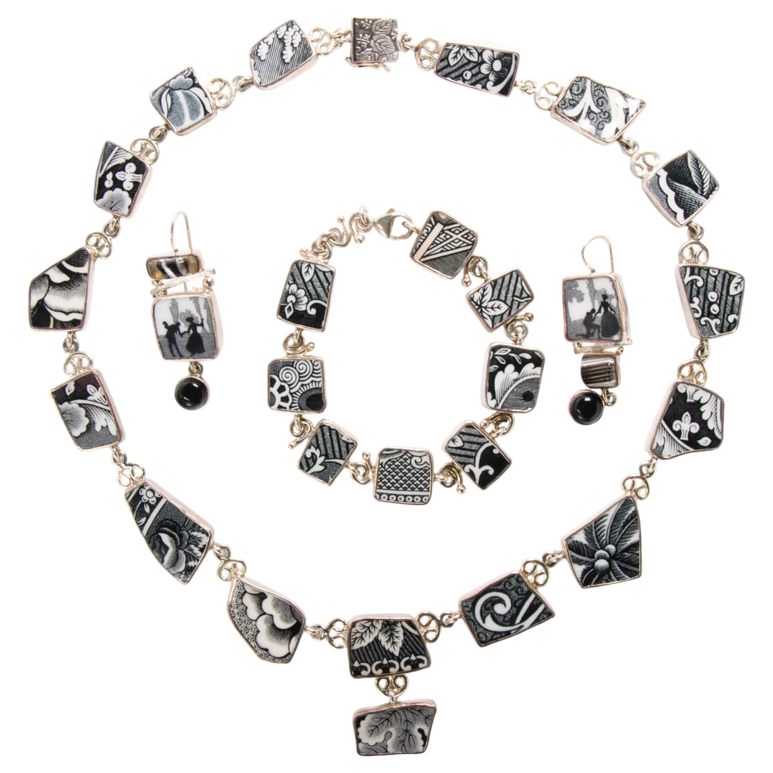A Lindsay Livingston sterling silver jewelry set: A Lindsay Livingston sterling silver jewelry set Comprising a necklace, bracelet, and pair of earrings set with freeform ceramic pieces; gross weight: 87.15 grams