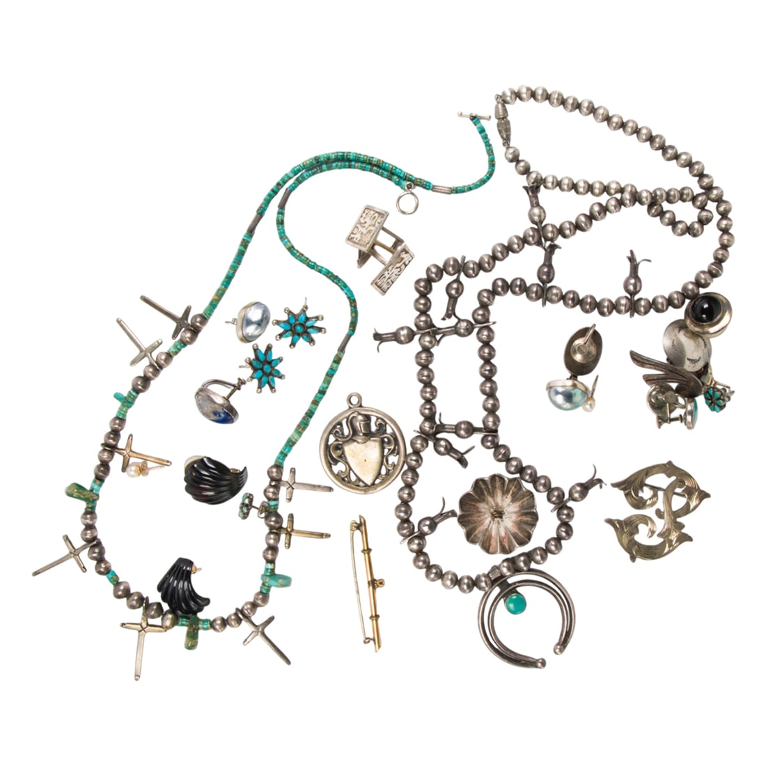 A group of miscellaneous silver jewelry: A group of miscellaneous silver jewelry comprising 7 pairs of earrings, two necklaces, one brooch, one pair of cufflinks, two buttons, three single earrings, and a pendant; 174.00 gross grams