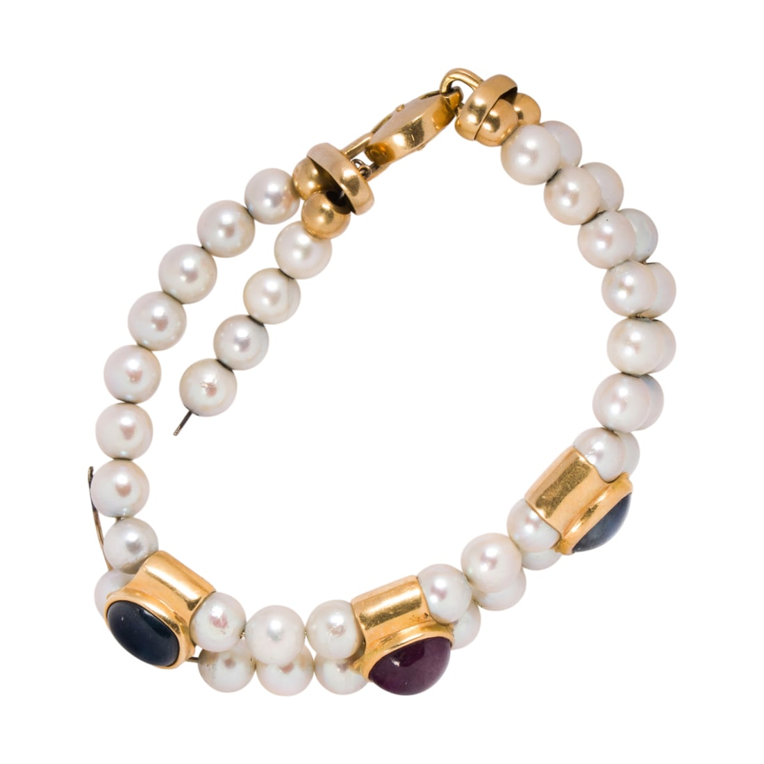 A cultured pearl, gemstone, and 18k gold bracelet: A cultured pearl, gemstone, and 18k gold bracelet The bracelet featuring two strands of cultured pearls measuring 6.80 grams, joined by 18k gold segments set with oval-shaped ruby and sapphire