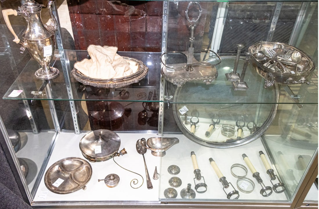 An assembled group of silver plate: An assembled group of silver plate, consisting of (7) candlesticks; (3) bobeches; (1) candle snuffer; (1) alcohol lamp; (1) dish warmer; (1) dinner plate; (5) serving dishes; (1) gravy server; (1)