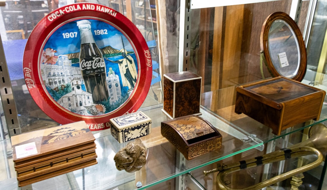 An assembled group: An assembled group, comprising (5) boxes; (1) 1982 Coca-Cola and Hawaii commemorative tin tray; (1) table top mirror and (1) composition group of seals, greatest 12"dia