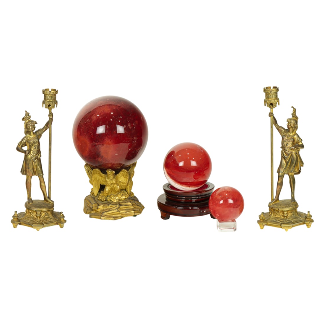 An assembled group: An assembled group, comprising a Continental pair of gilt bronze Centurion candleholders, 12"h and three red slag glass spheres on stands, between 4"h and 10.5"h [5 total]
