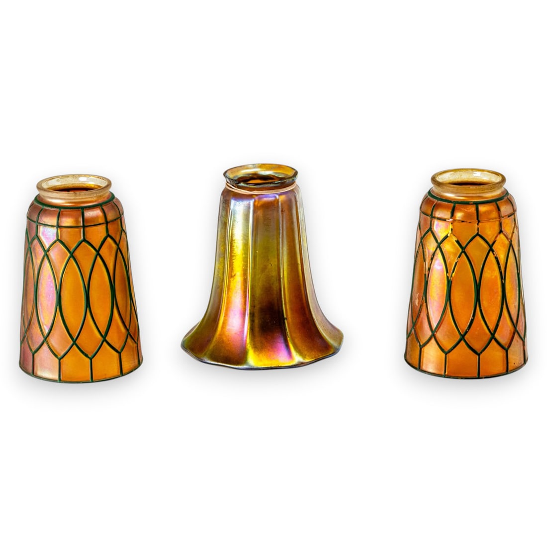 A Steuben gold Aurene glass shade: A Steuben gold Aurene glass shade, acid etched factory mark, 5.5"h; 2.25"dia (fitter); together with a pair of Arts & Crafts glass shades, 5.5"h; 2.25"dia (fitter) [3 total]