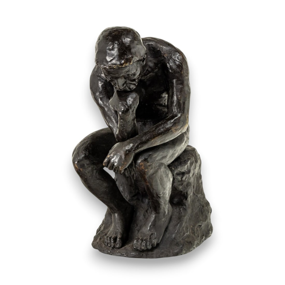 A patinated bronze figure of The Thinker: A patinated bronze figure of The Thinker, after Rodin, incised 'V. Martin', 18"h