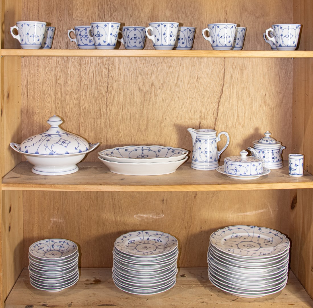 A Reinecke blue and white porcelain dinner service in a Strawflower pattern: A Reinecke blue and white porcelain dinner service in a Strawflower pattern, marked, comprising of (11) tea cups and (12) saucers; (1) covered serving bowl; (2) open serving dishes; (1) cream