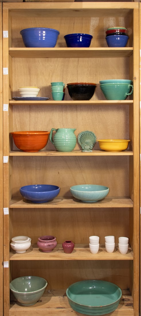 An assembled group of pottery: An assembled group of pottery, comprising mostly of Bauer, Hall, Roseville, and Pewabic, consisting of (3) mixing bowls between 5"h x 10"dia and 5.5"h x 11"dia; (5) serving bowls between 4.5"h x