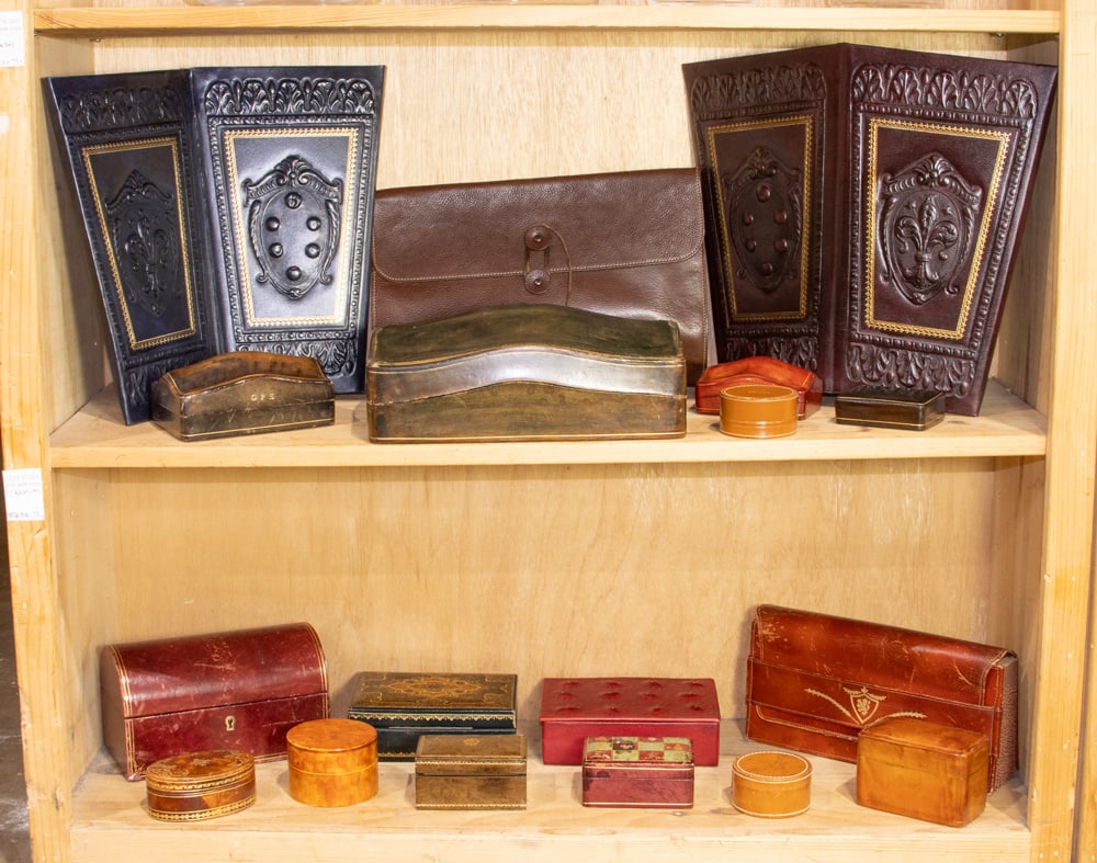 An assembled group of mostly vintage leather-bound trinket boxes: An assembled group of mostly vintage leather-bound trinket boxes, comprising (13) boxes between 2.5"dia and 10.5"l x 8"w, together with a leather envelope holder, organizer, and (2) waste baskets [16 