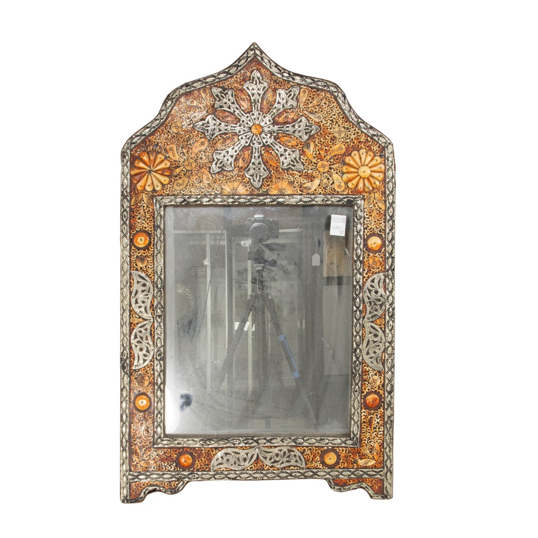 A Moroccan metal and bone mounted arched mirror