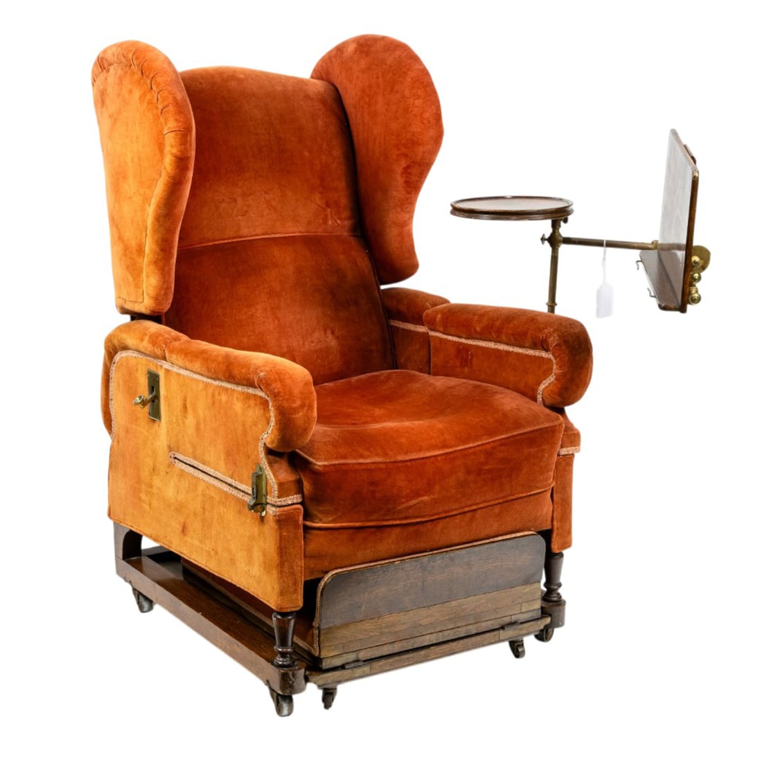A Victorian 'Burlington' metamorphic reclining wingback chair: A Victorian 'Burlington' metamorphic reclining wingback chair, J. Foot & Sons, London, featuring mechanical recliner, integrated reading desk, retractable footrest and hinged sides, 48"h x 27"w x