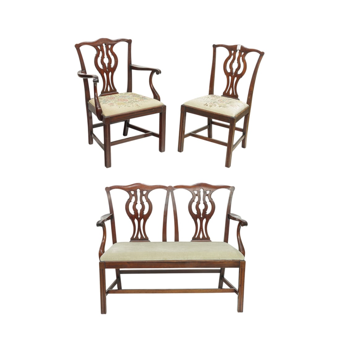 A Chippendale style seating group: A Chippendale style seating group, each having cupids bow crest above a pierced splat, comprising settee: 37"h x 43"w x 18.5"d; armchair: 36.5"h x 25"w x 18"d, and a sidechair: 35.5"h x 19"w x 17.5"d