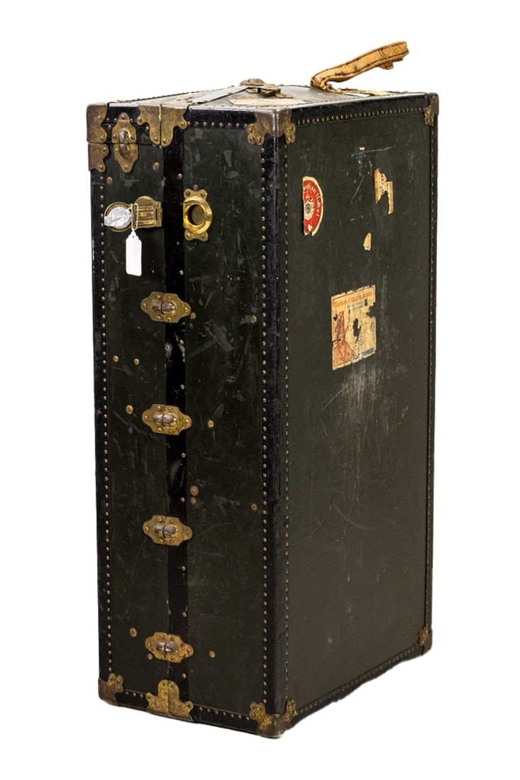 An American wardrobe trunk: An American wardrobe trunk, Oshkosh Trunk Co, first quarter 20th century, featuring brass corners and studs, 42"h x 15"w x 22.5"d