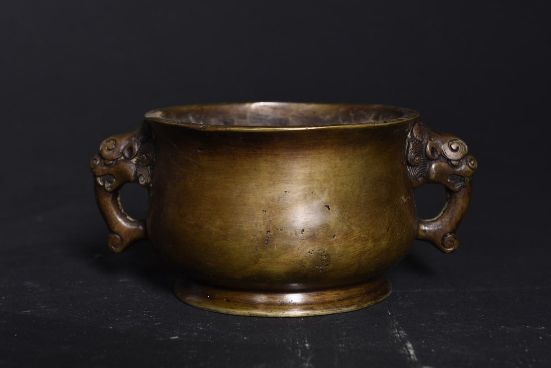 Chinese bronze lion head handled censer: A Chinese bronze lion-head handled censer. Bearing a six-character on the base, 5.5" wide.