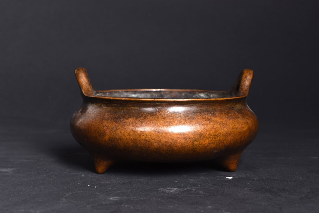 Chinese cast bronze tripod censer: A Chinese cast bronze tripod censer. Bearing a three-character mark on the underside, 7" wide.