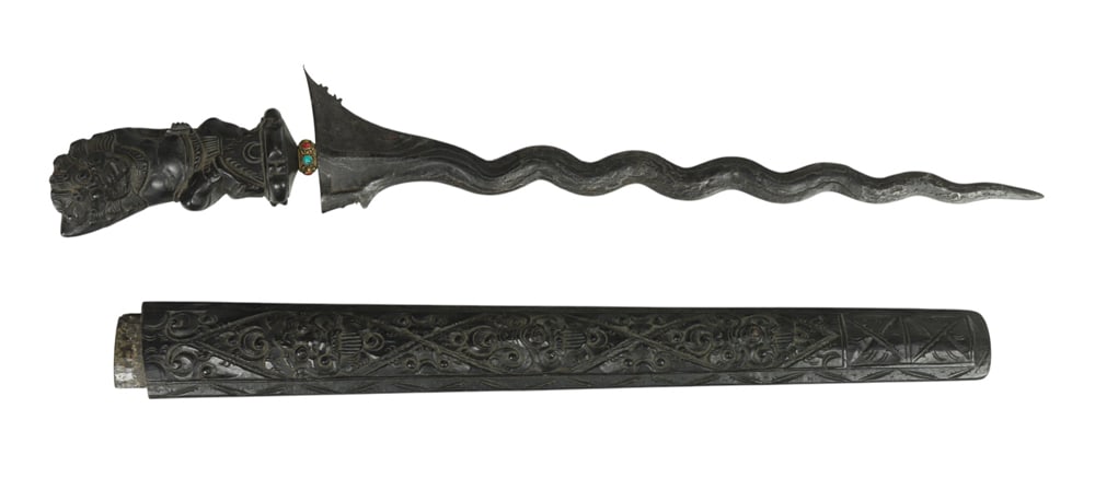 An Indonesian keris: An Indonesian keris. With carved wood sheath and hilt, 20th century, 23" long