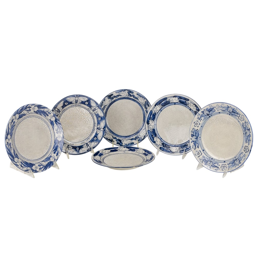 A group of six Dedham Pottery crackle ware plates: A group of six Dedham Pottery crackle ware plates, late 19th/first half 20th century, comprising one plate with pomegranate and flower border, incised rabbit mark; three plates each with blue printed
