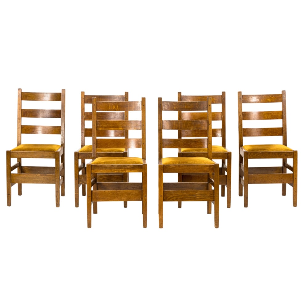 A set of six Gustav Stickley ladder back chairs: A set of six Gustav Stickley ladder back chairs, each with drop in seat, branded mark, and retain paper label under seat, 36"h x 17"w x 21"d (overall); 19"h x 15.5"d (seat)
