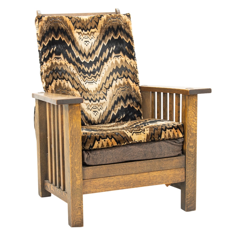 An Arts and Crafts Morris chair: An Arts and Crafts Morris chair, adjustable back with metal hardware, slide out footstool, and thru tenon construction, 39.5"h x 31"w x 33"d (overall); 17"h x 22"d (seat)