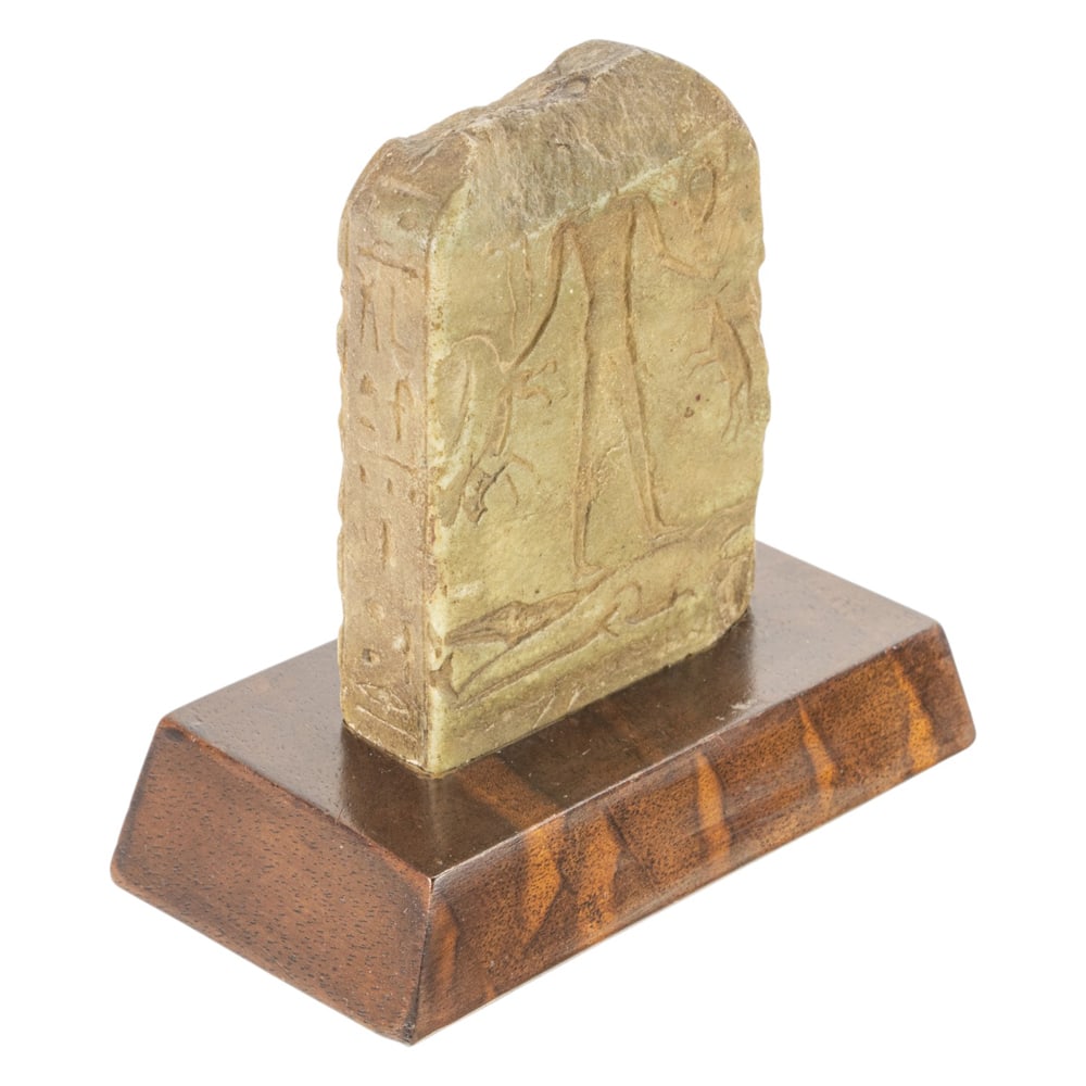 An Egyptian stela: Egyptian stela, with hieroglyphs encompassing entire stone, and depicting Baal, 3.5"h x 2.5"w (ex. Sotheby's London)