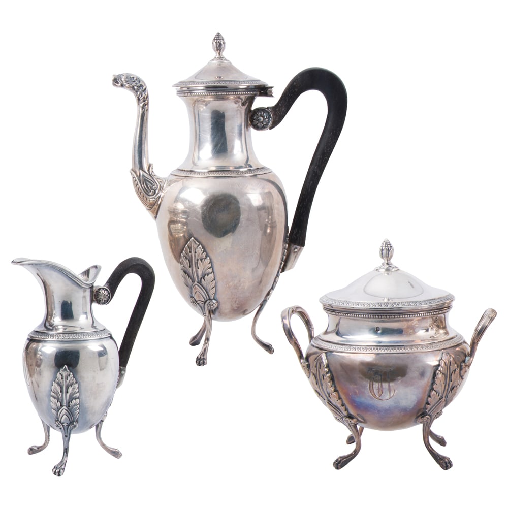 A French export 950 standard silver three piece small coffee set in the Empire taste, Boulenger,: A French export 950 standard silver three piece small coffee set in the Empire taste, Boulenger, Paris, monogrammed: T, comprising: pot, cream pitcher, both with wooden handles and sugar bowl with