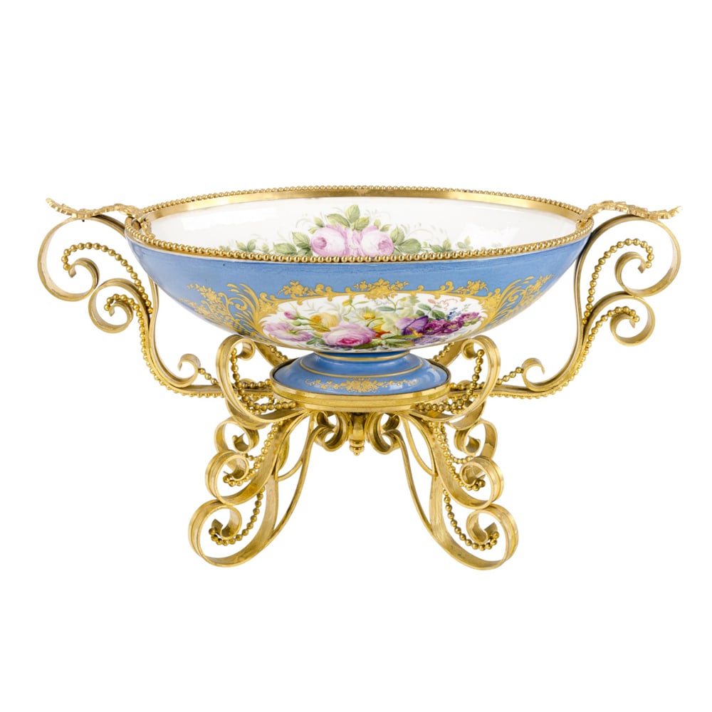 A large Sevres style porcelain gilt bronze mounted center bowl: A large Sevres style porcelain gilt bronze mounted center bowl, late 19th/early 20th century, painted with floral sprays on a turquoise blue ground and raised in scrolling footed frame, 13.25"h x