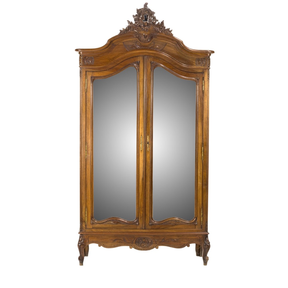 A Rococo style linen press: A Rococo style linen press, the two mirrored doors surmounted by the rocaille crest, and rising on outswept legs, 98.5"h x 48.5"w x 17"d