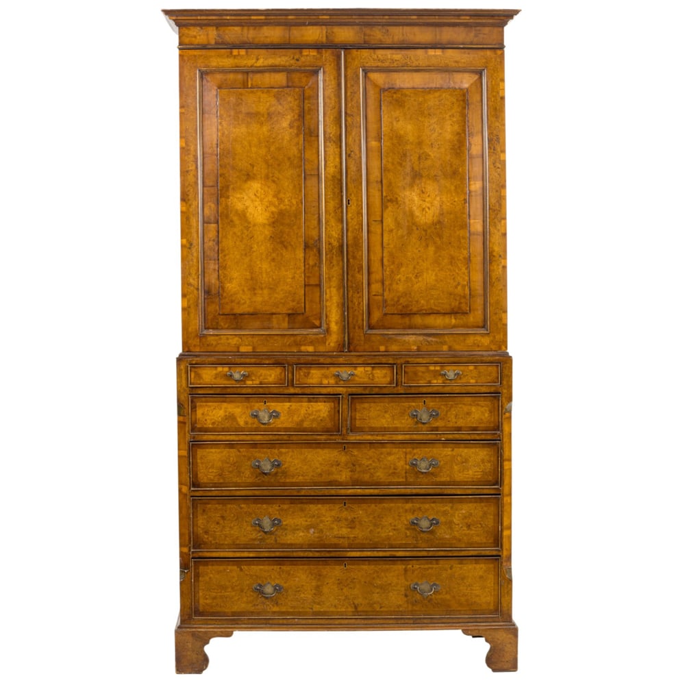A Georgian style linen press: A Georgian style linen press, late 19th century, the burl decorated case with a two door super structure resting on the lower case having eight graduated drawers, and rising on bracket feet, 89"h x