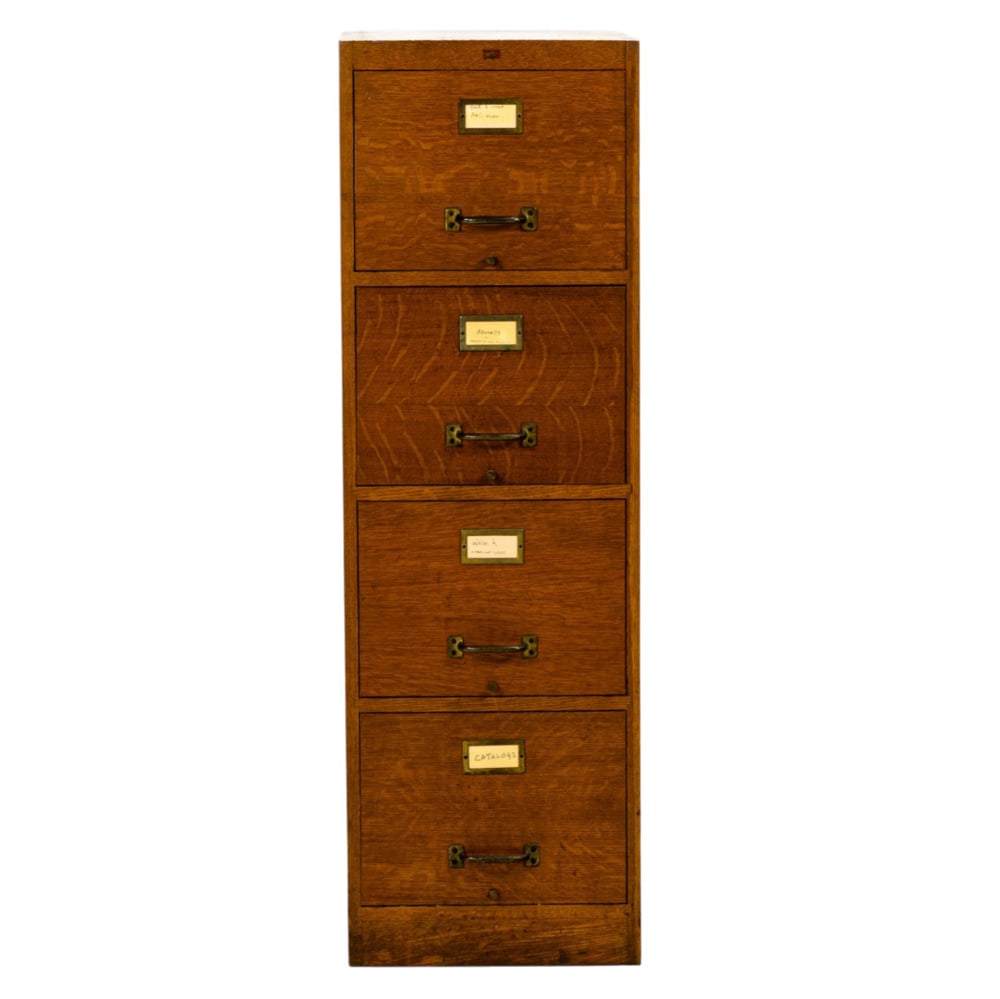 An oak four drawer file cabinet: An oak four drawer file cabinet, 52"h x 25"w x 16.5"d