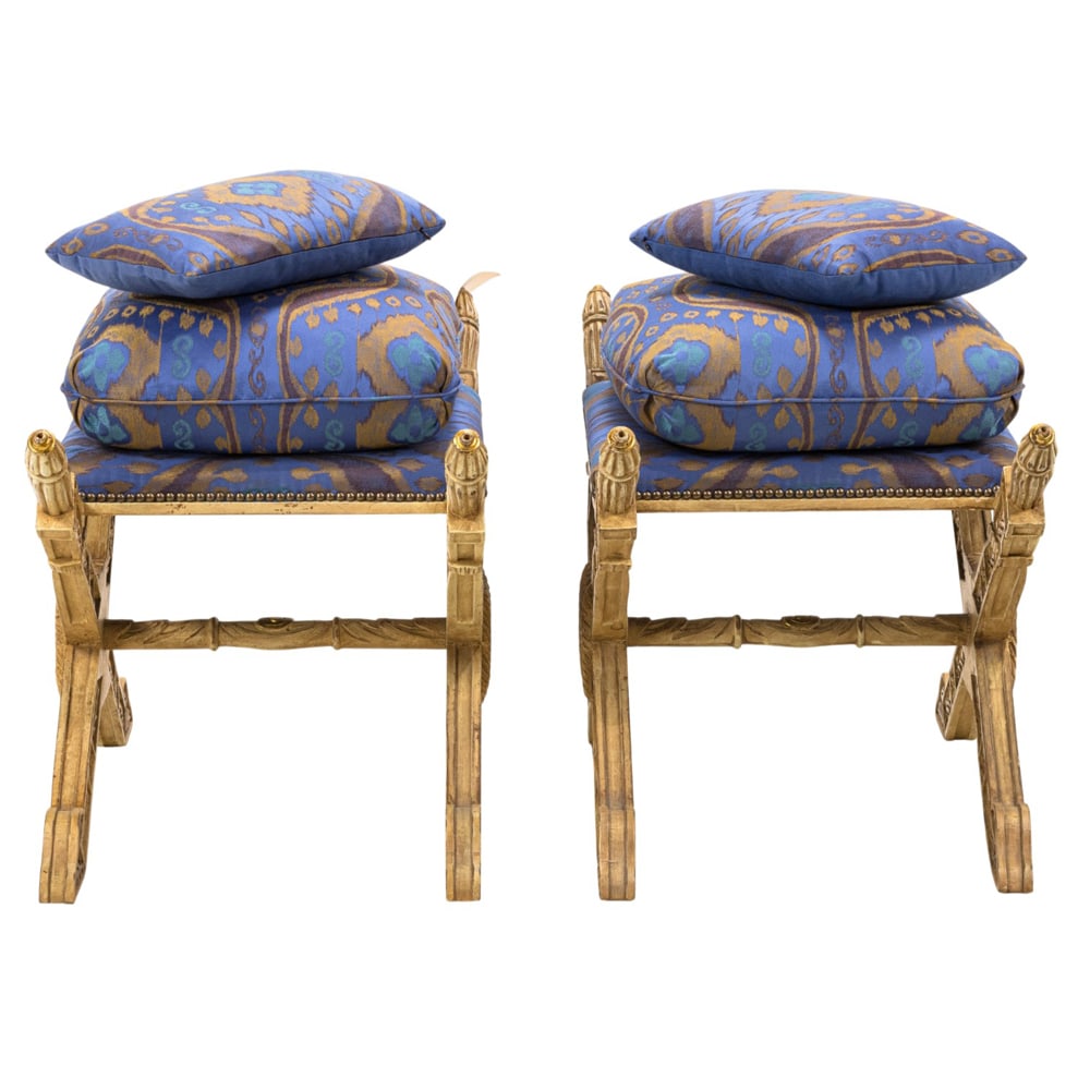 A pair of custom Empire style giltwood sabre stool and two matching throw pillows: A pair of custom Empire style giltwood sabre stool and two matching throw pillows, Antonio's San Francisco, 22.5"h x 35.5"w x 19"d (overall); 20"h x 20"d (seat). Provenance: A private collection,