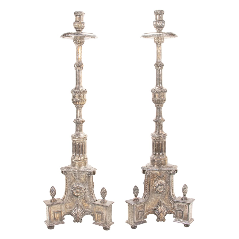 A monumental pair of Indian metal clad candle prickets: A monumental pair of Indian metal clad candle prickets, each ornately decorated with stiff leaves, petals, rosettes and ropetwist bands, purchased Living Green, San Francisco, 83.5"h x 26"sq (base).