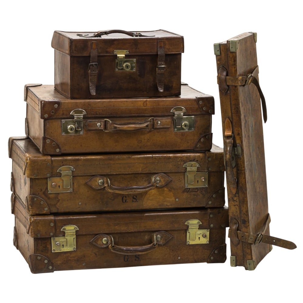 A group of five English leather travel cases: A group of five English leather travel cases, by various makers including John Blanch & Son, Smith Englefied & Co., and Hardy Bros., Ltd, comprising (1) gun case, 12"h x 32"w x 11.5"d; (2) cases,