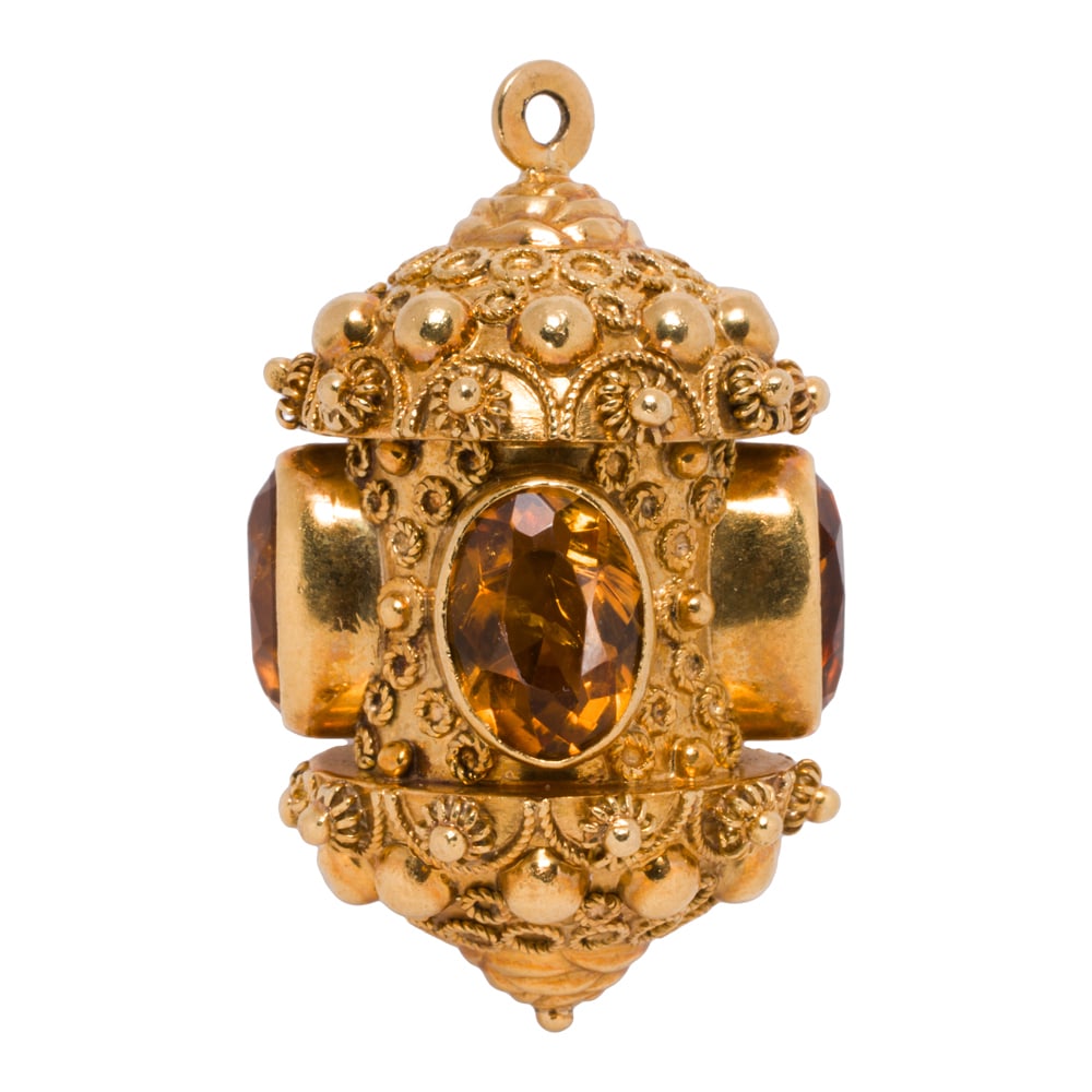 A vintage Etruscan style citrine and 18k gold charm: A vintage Etruscan style citrine and 18k gold charm Featuring intricate wire-work and granulation, set with four oval-cut citrines measuring 11.00 x 7.61 mm; length: 1 3/4 in; 21.65 grams
