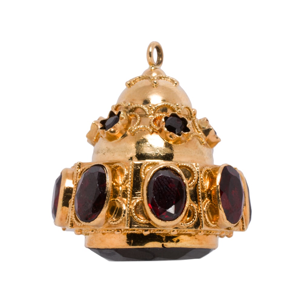 A vintage Etruscan style garnet and 18k gold charm: A vintage Etruscan style garnet and 18k gold charm The bell-form charm featuring 15 oval and round-cut garnets of varying sizes accented by intricate wire work; length: 1 1/8 in; 17.85 grams