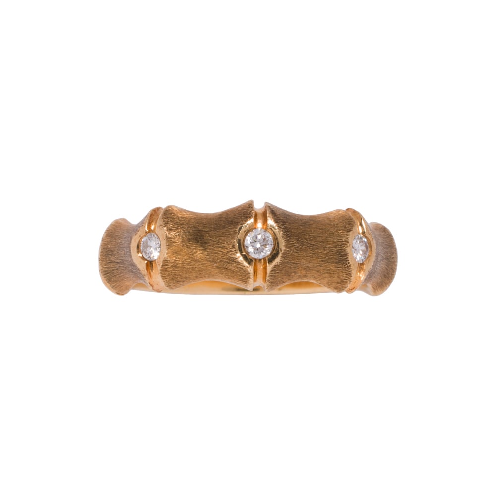 A diamond and 14k gold ring: A diamond and 14k gold ring Designed as bamboo, set with three round brilliant-cut diamonds; size 7; 4.80 grams