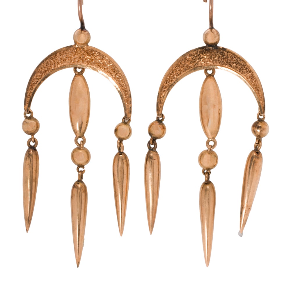 A pair of antique 14k gold earrings: A pair of antique 14k gold earrings Of Etruscan style, featuring drop form charms suspended from a textured crescent moon; length: 2 1/2 in; 6.15 grams